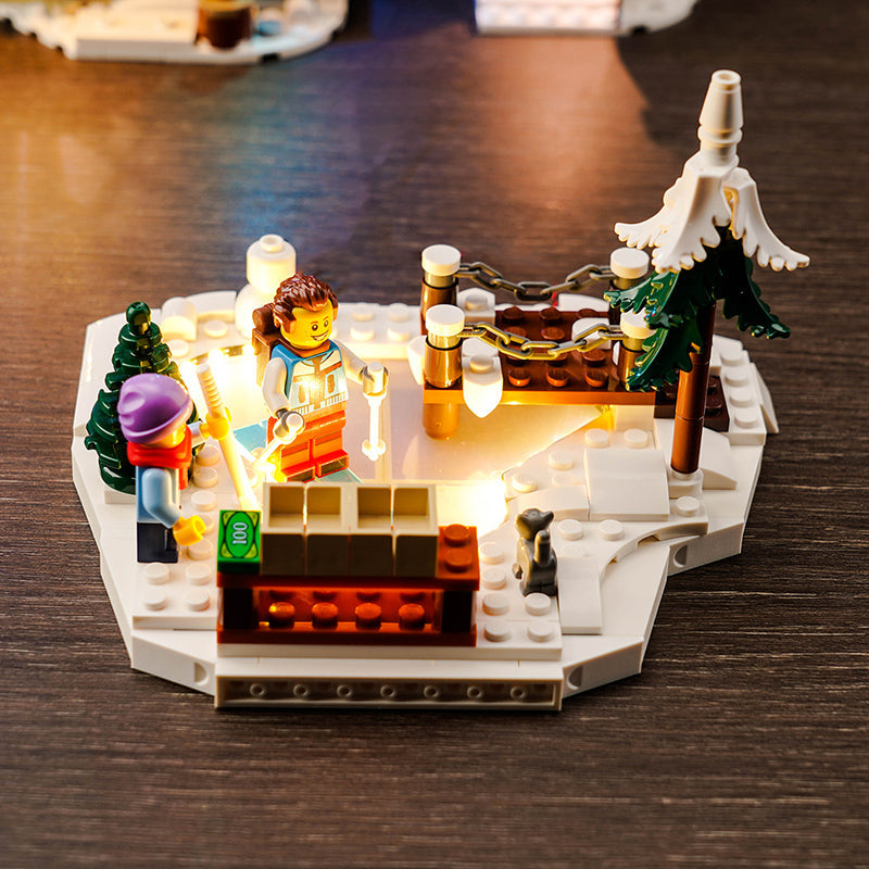 Beleuchtetes Lego Set mit zwei Minifiguren in einer verschneiten Winterlandschaft