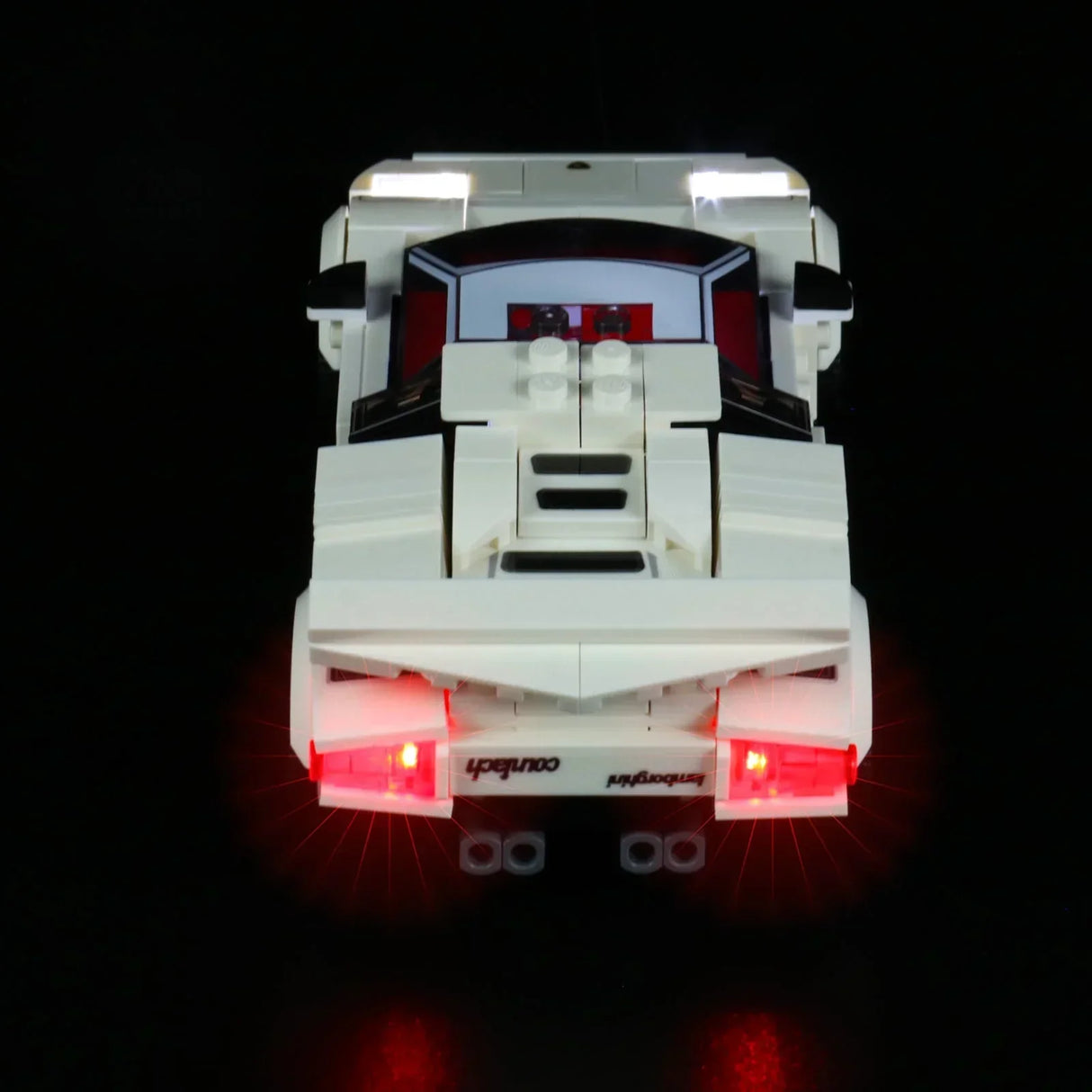 Weißes Lamborghini Countach Modell aus Klemmbausteinen mit leuchtenden roten Rücklichtern auf schwarzem Hintergrund