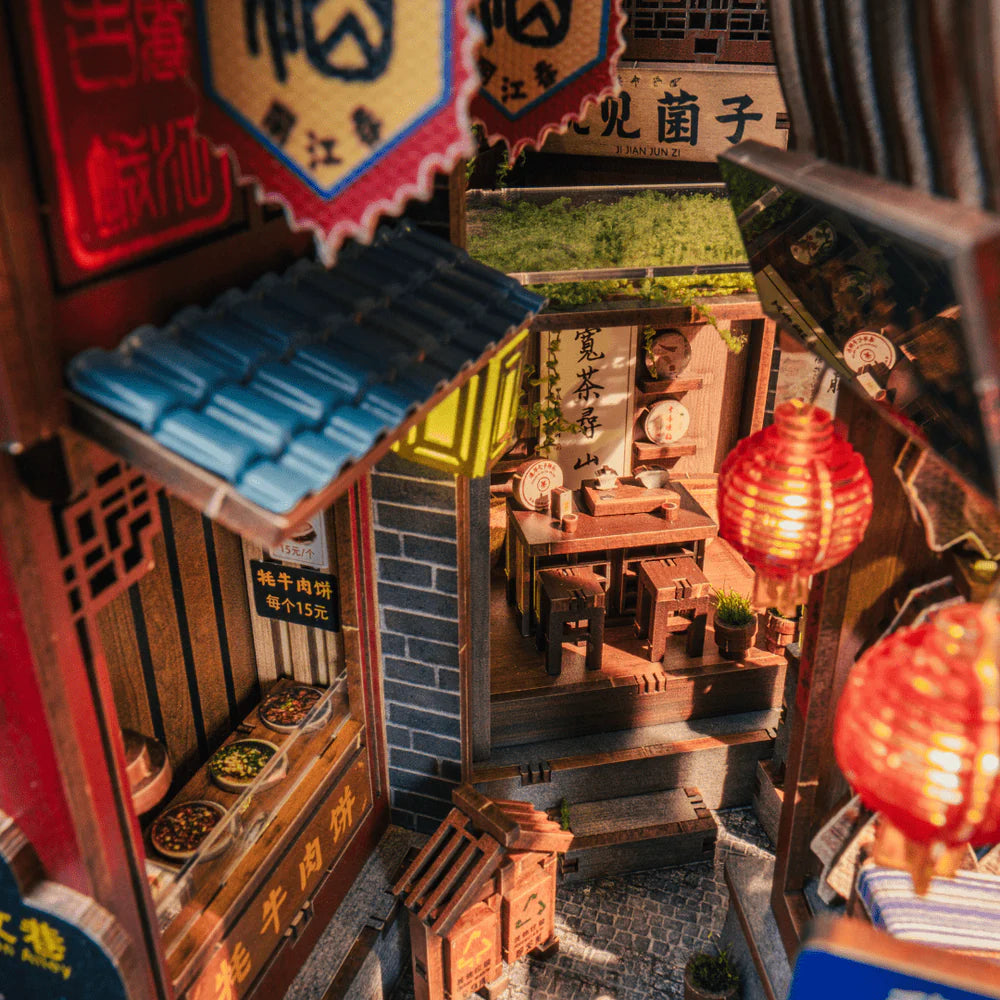 Miniatur-Diorama einer belebten chinesischen Gasse mit Geschäften, Laternen und einem Teeladen