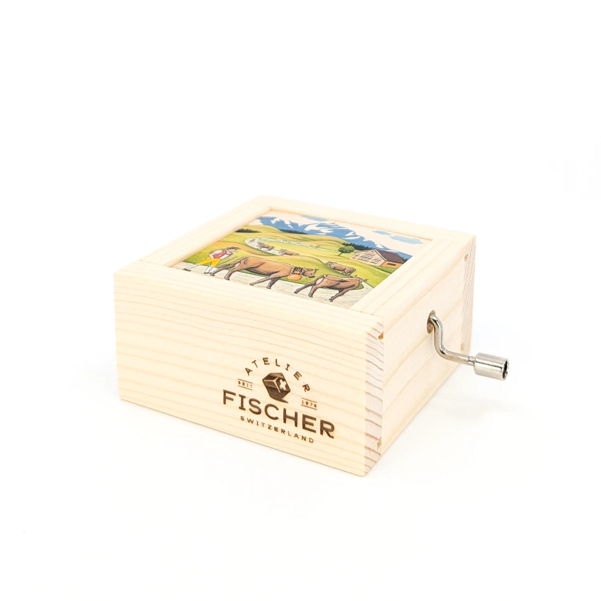 Holzspieldose mit Kurbel und aufgedruckter Schweizer Berglandschaft mit Kühen und Logo von Atelier Fischer