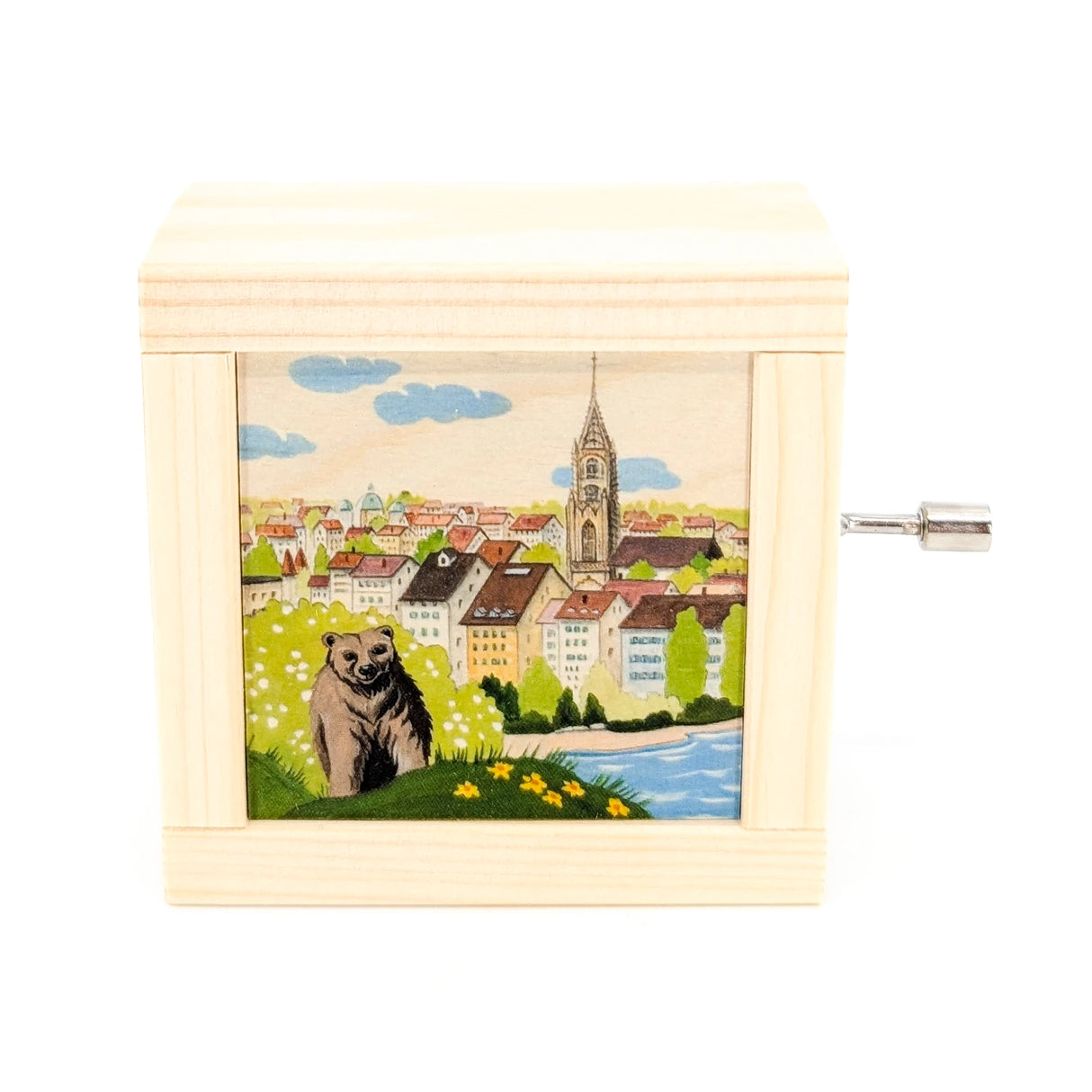 Spieluhr aus Holz mit einer Illustration eines Bären vor einer Stadtlandschaft mit Fluss und Kirchturm