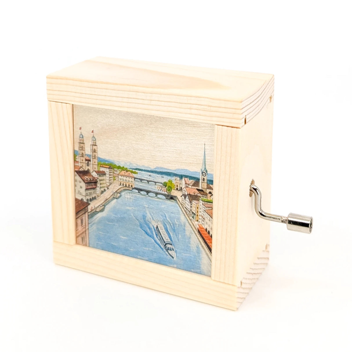 Spieluhr aus Holz mit aufgedruckter Ansicht der Zürcher Altstadt und Kurbel an der Seite