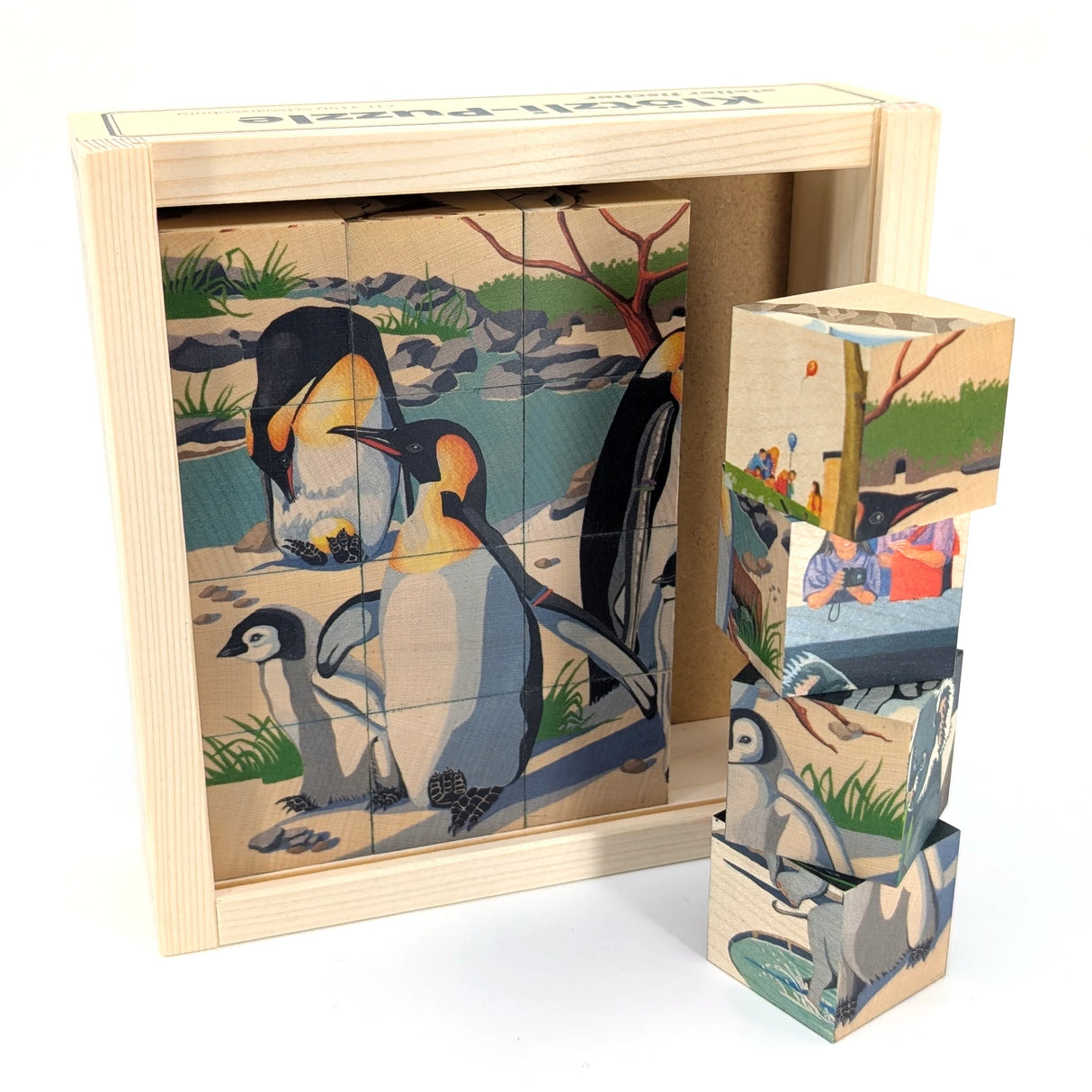 Holzklotz-Puzzle mit Pinguinmotiv in Holzkiste
