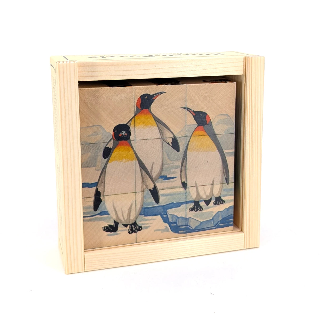 Holzpuzzle mit drei Pinguinen auf Eisschollen