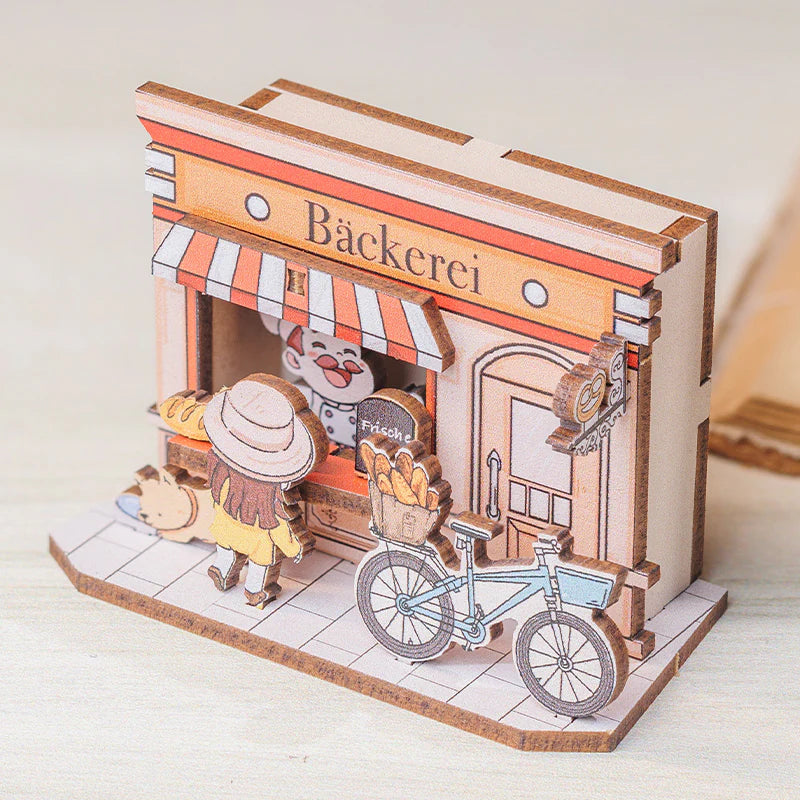 Miniatur-Holzmodell einer Bäckerei mit Bäcker, Kundin und Fahrrad