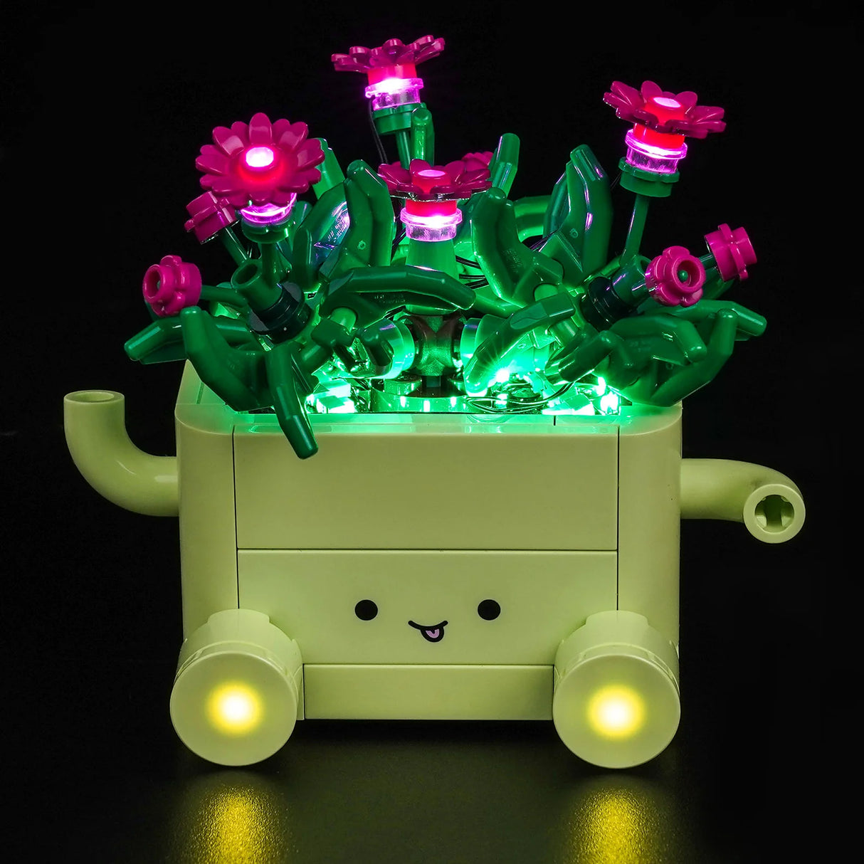 Hellgrüner LEGO-Blumentopf mit einem Gesicht und vielen pinken Blumen, die durch BrickBling LEDs farbenfroh beleuchtet werden.