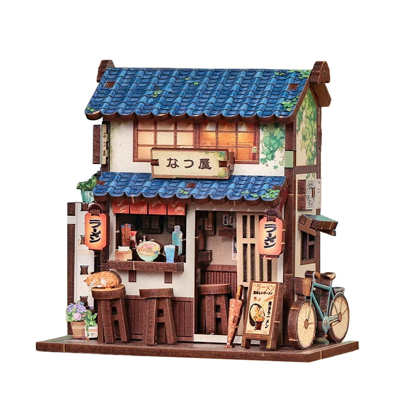 Miniatur-Ramen-Laden mit blauen Ziegeln, einem schlafenden Kätzchen und einem Fahrrad