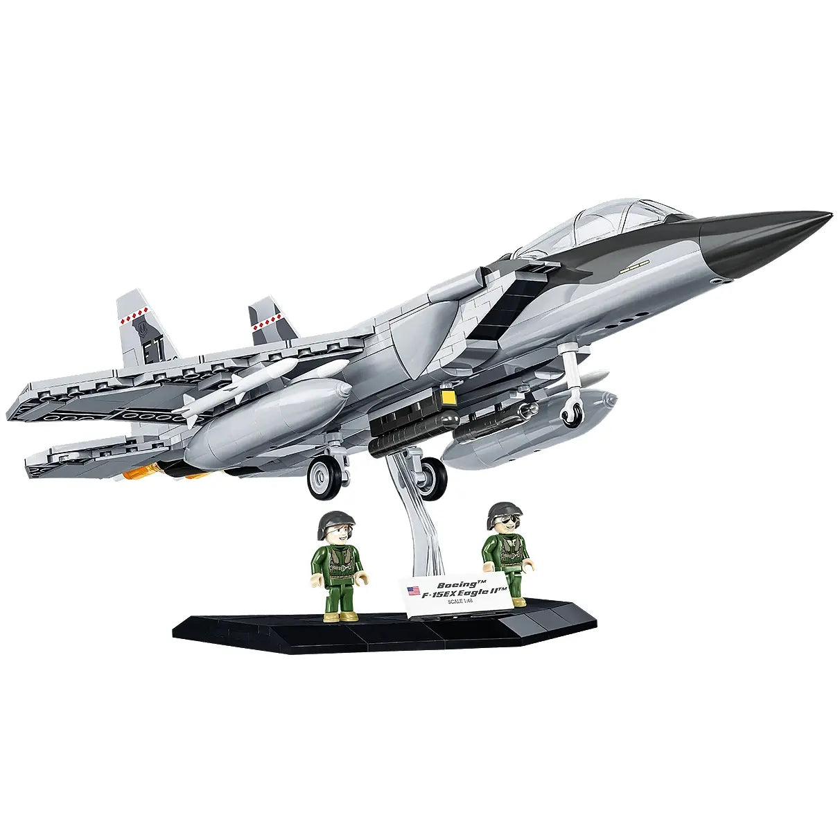 Graues Spielzeug-Kampfflugzeug mit zwei Pilotenfiguren auf schwarzem Ständer