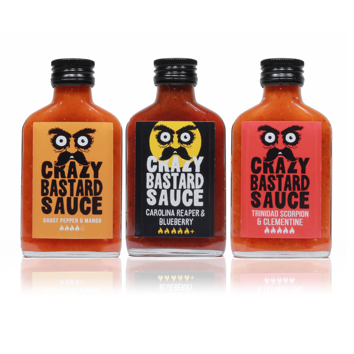 Drei Flaschen Crazy Bastard Sauce mit verschiedenen Geschmacksrichtungen auf weißem Hintergrund