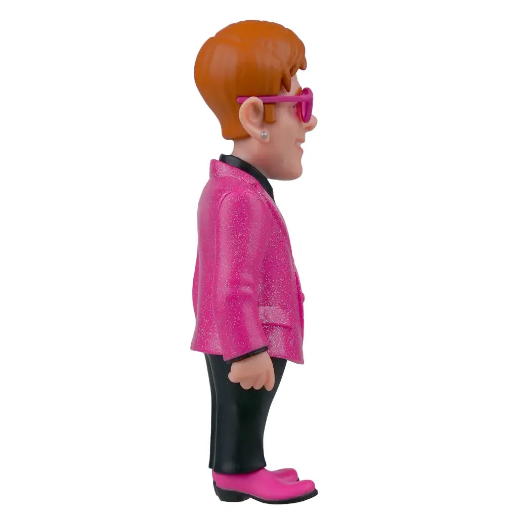 Elton John Figur mit rotem Haar, rosa Glitzerjacke, schwarzer Hose und rosa Schuhen