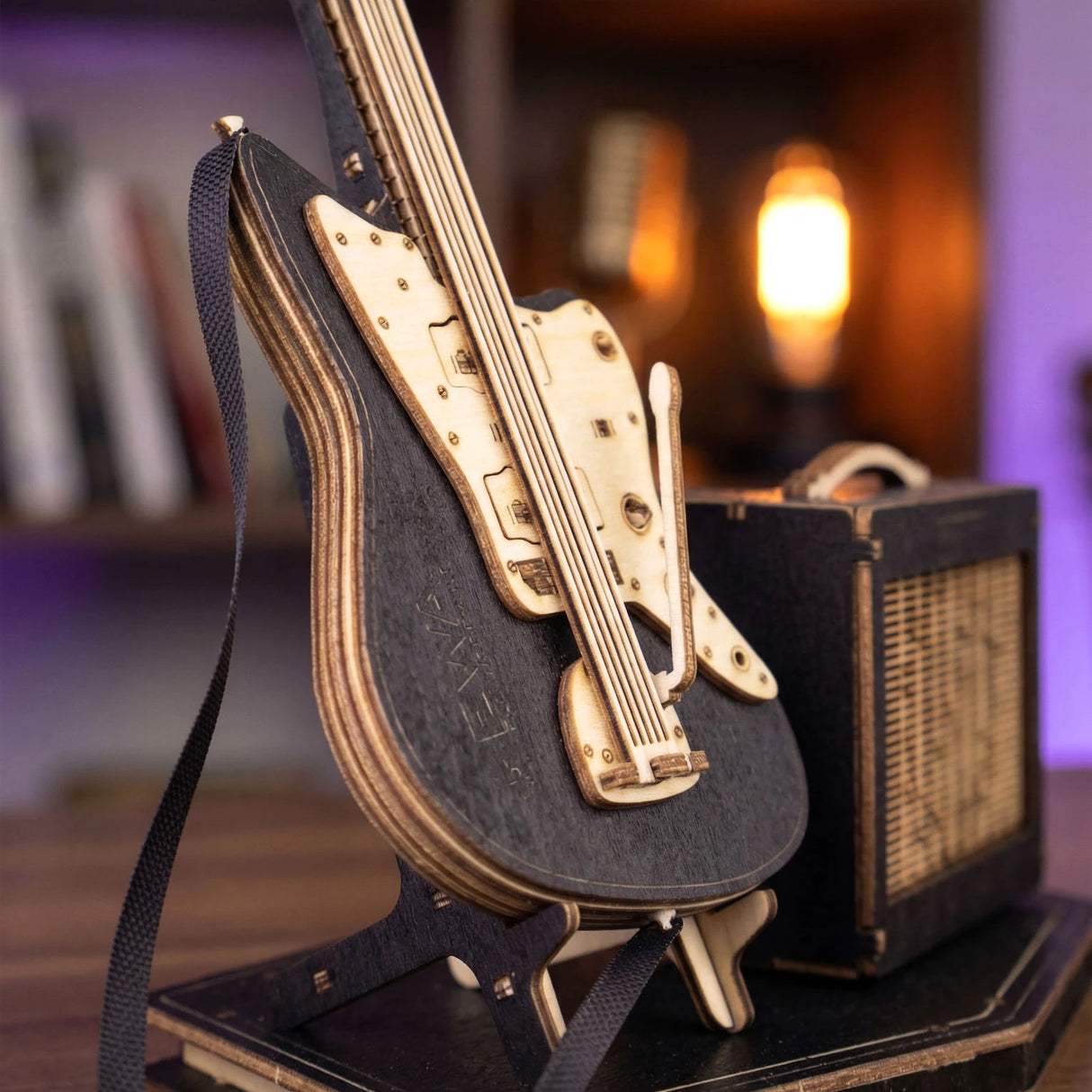 Modell einer schwarzen E-Gitarre aus Holz mit hellem Griffbrett und Verstärker