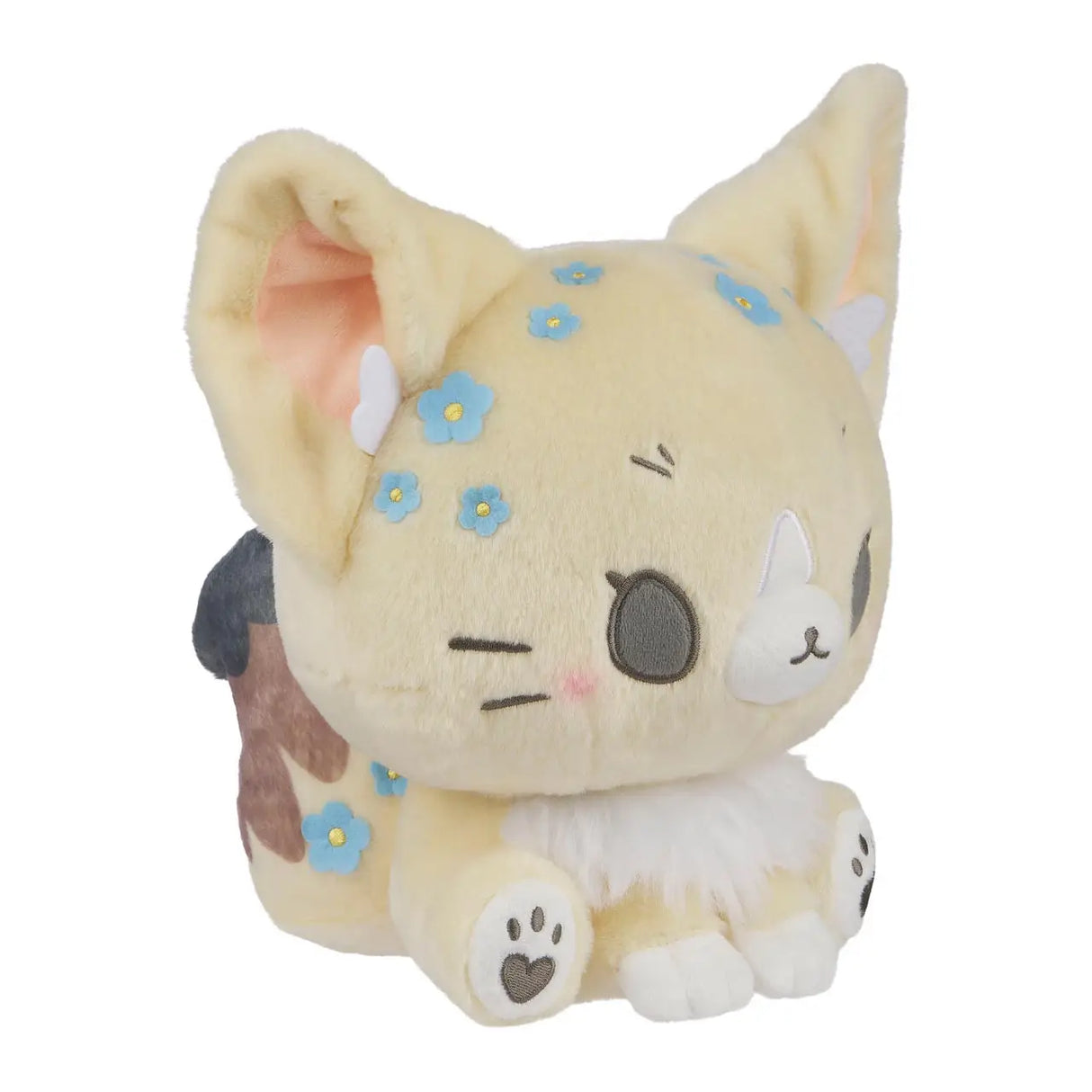 Cremefarbenes Plüschtier einer Katze mit blauen Blumen und braunen Flecken