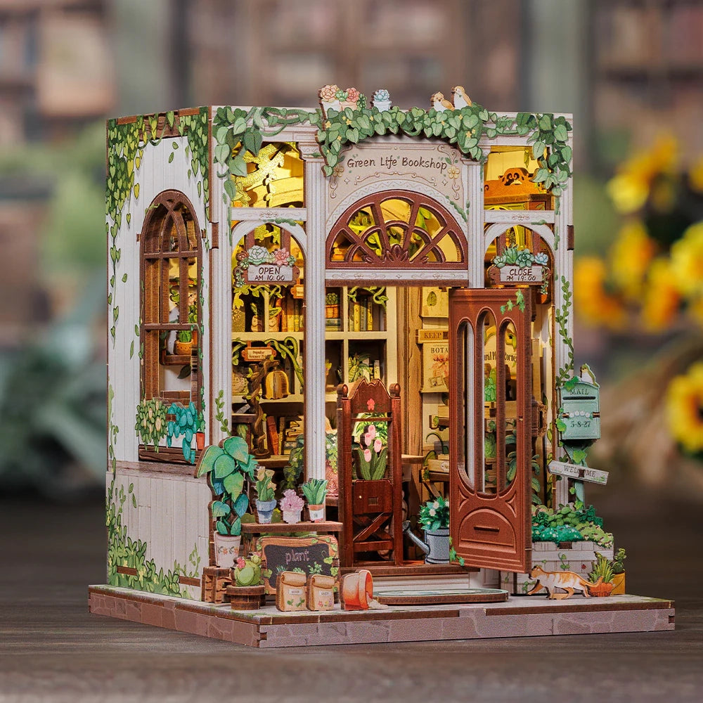Miniatur-Buchhandlung mit Pflanzen und Schildern Green Life Bookshop