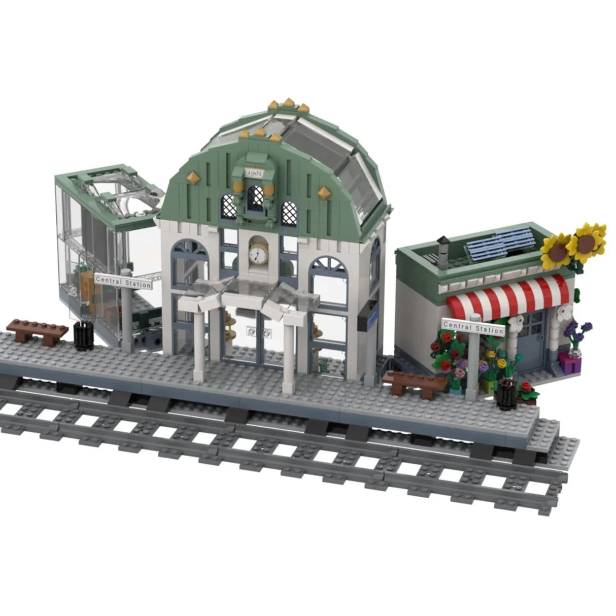 Lego-Modell eines Bahnhofs mit Gleisen, einem Hauptgebäude, einem Blumenladen und einer Treppe