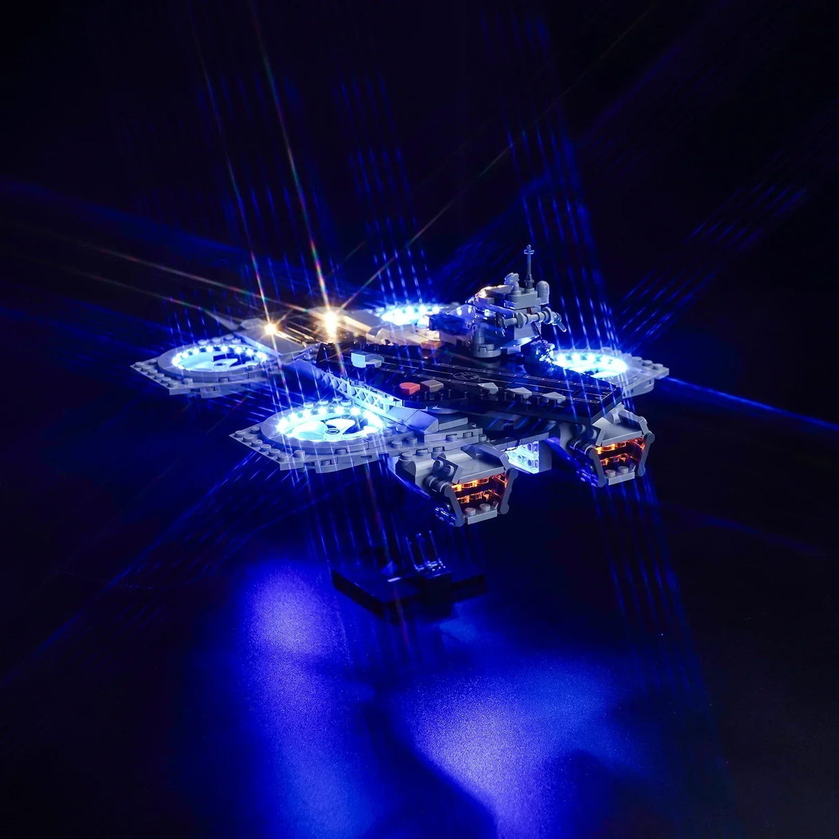 Beleuchtetes Modell eines fliegenden Flugzeugträgers mit blauen LED Lichtern vor schwarzem Hintergrund