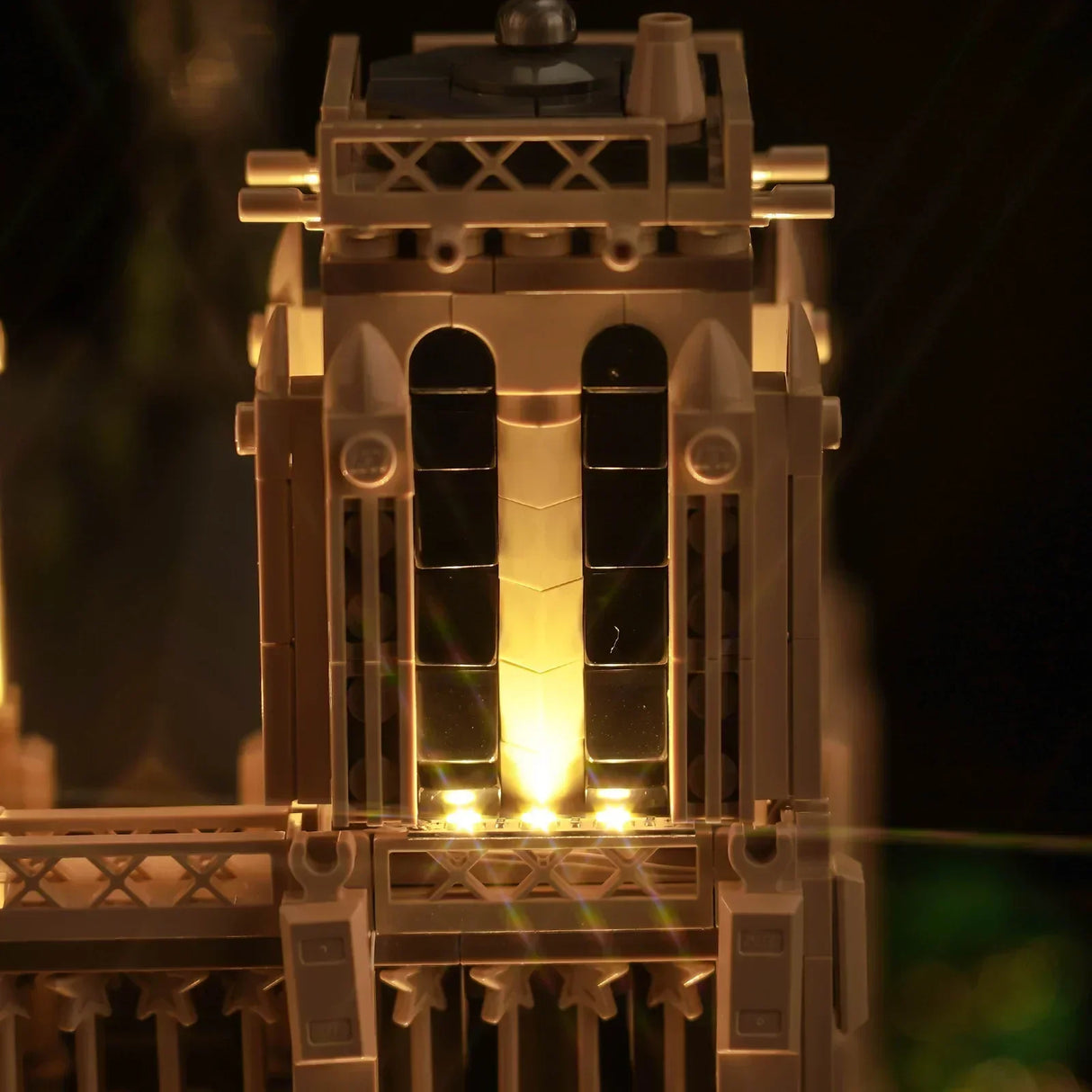 Beleuchteter Turm aus Klemmbausteinen bei Nacht