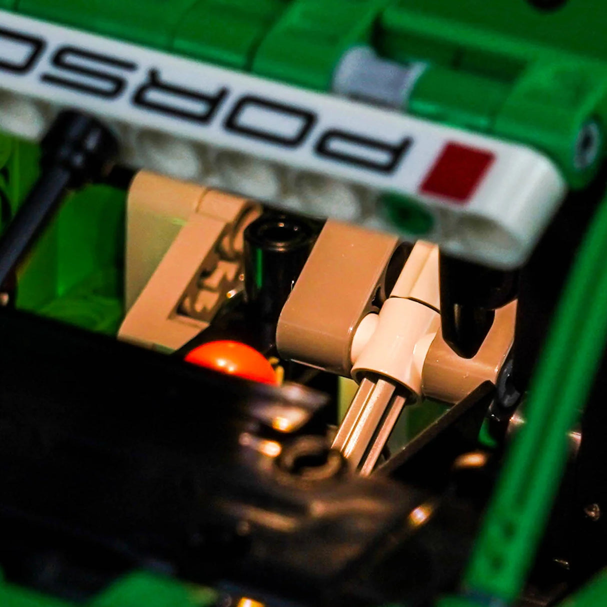 Nahaufnahme eines Lego Porsche Modells mit dem Porsche-Logo auf einem weißen Streifen