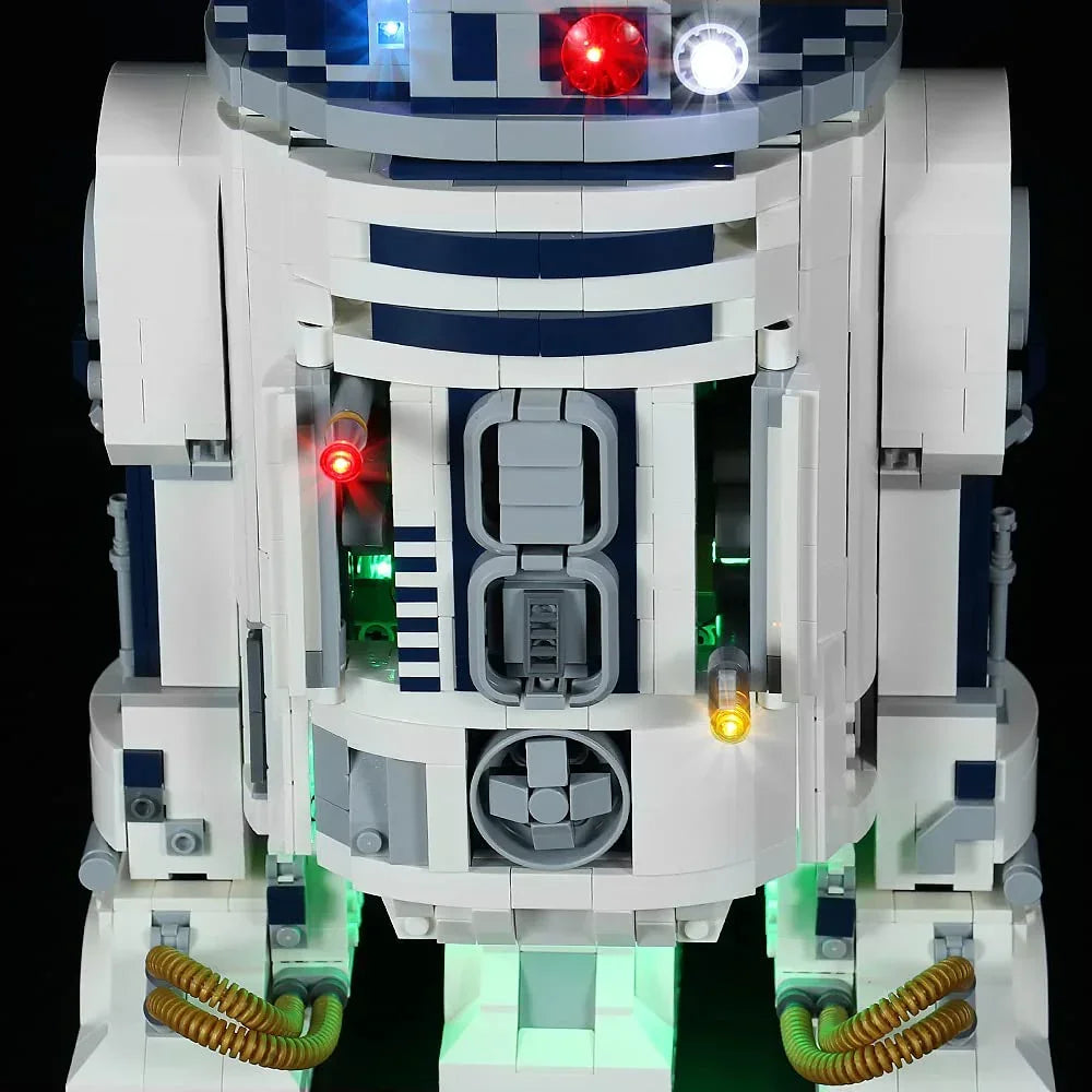 Beleuchtetes R2-D2 Modell aus Klemmbausteinen vor schwarzem Hintergrund
