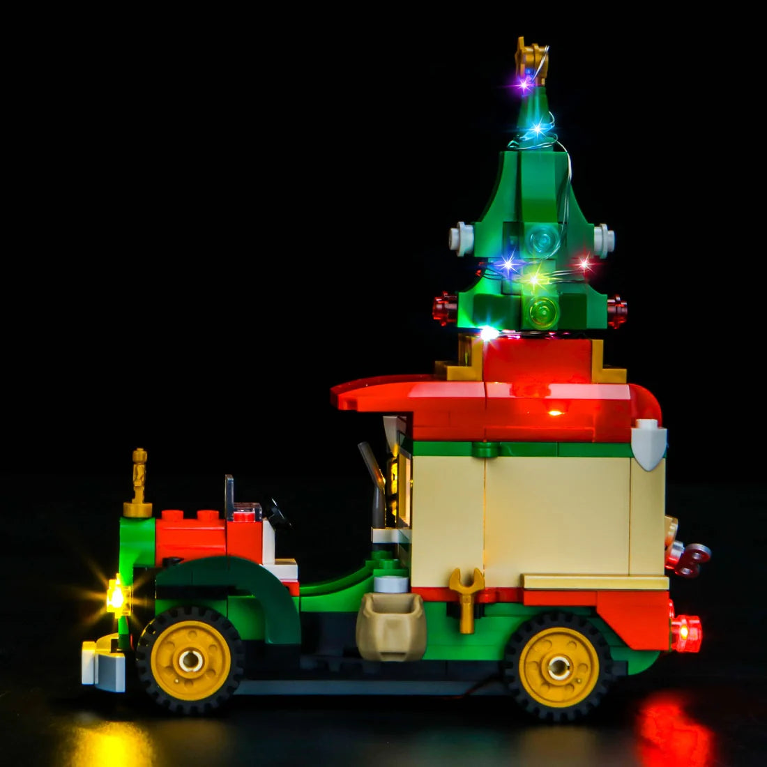 Beleuchtetes Lego Weihnachtsauto mit Tannenbaum auf dem Dach vor schwarzem Hintergrund