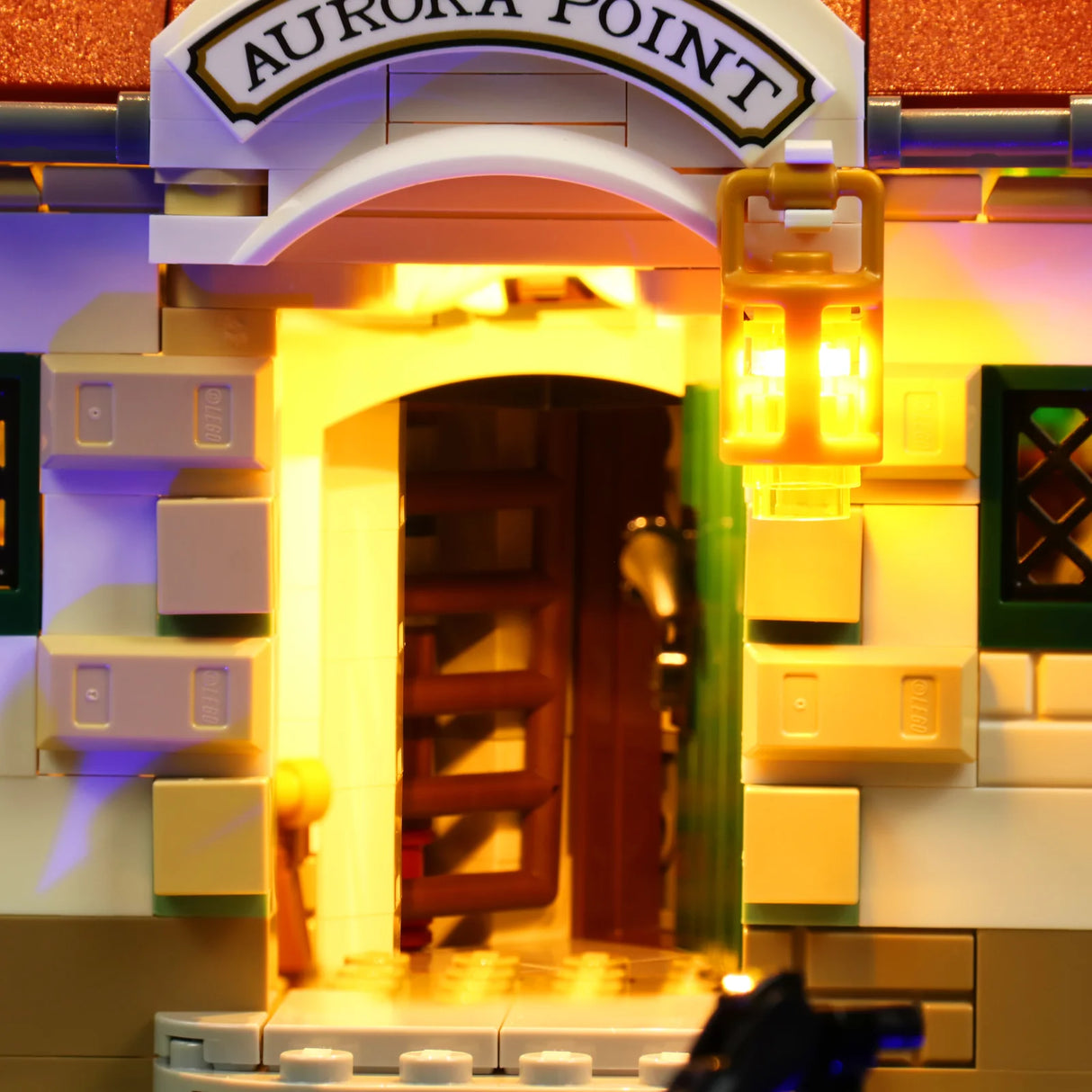 Nahaufnahme eines beleuchteten Lego-Gebäudes mit einem Schild Aurora Point und einer leuchtenden Laterne