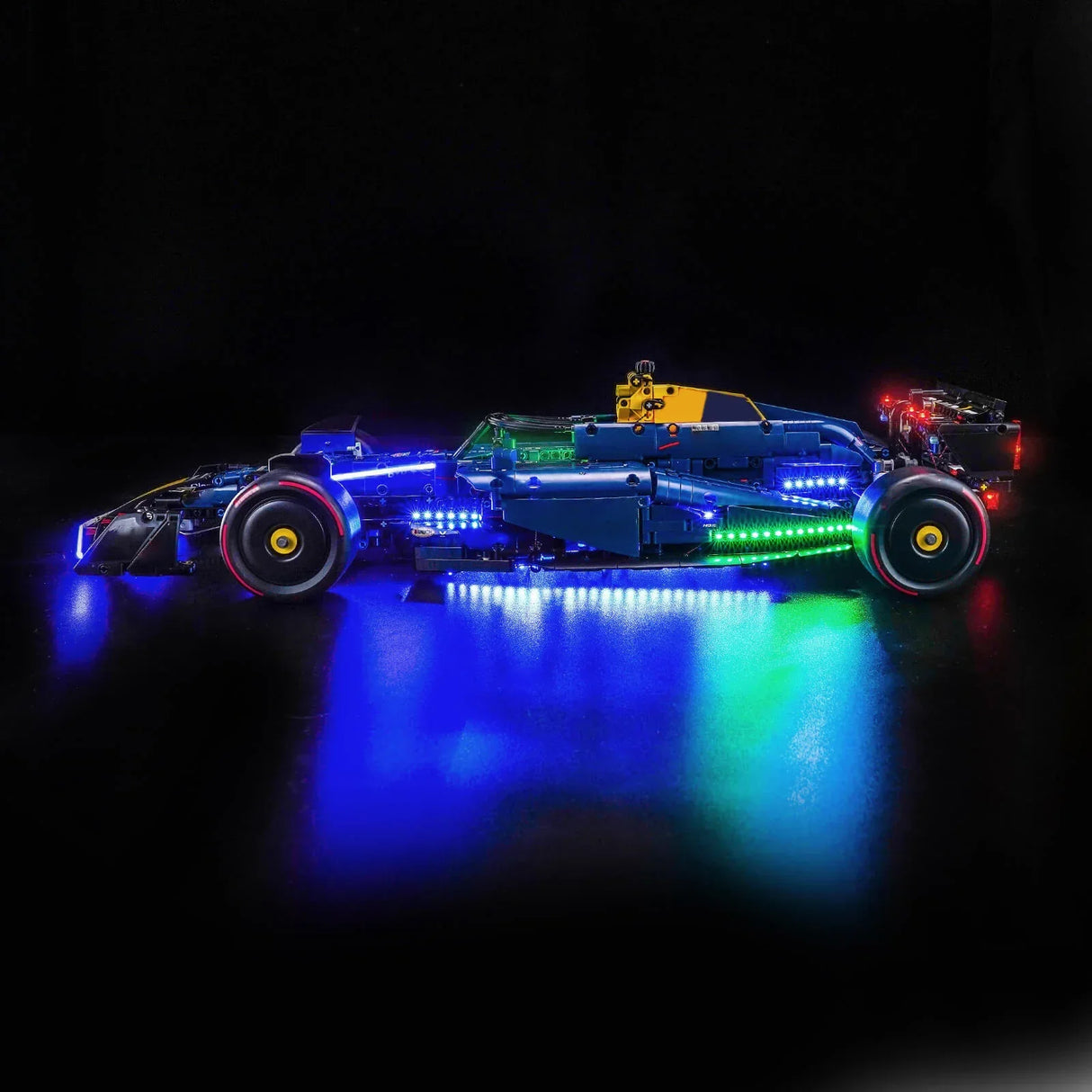 Beleuchtetes Formel-1-Modellauto in Blau und Grün auf schwarzem Hintergrund