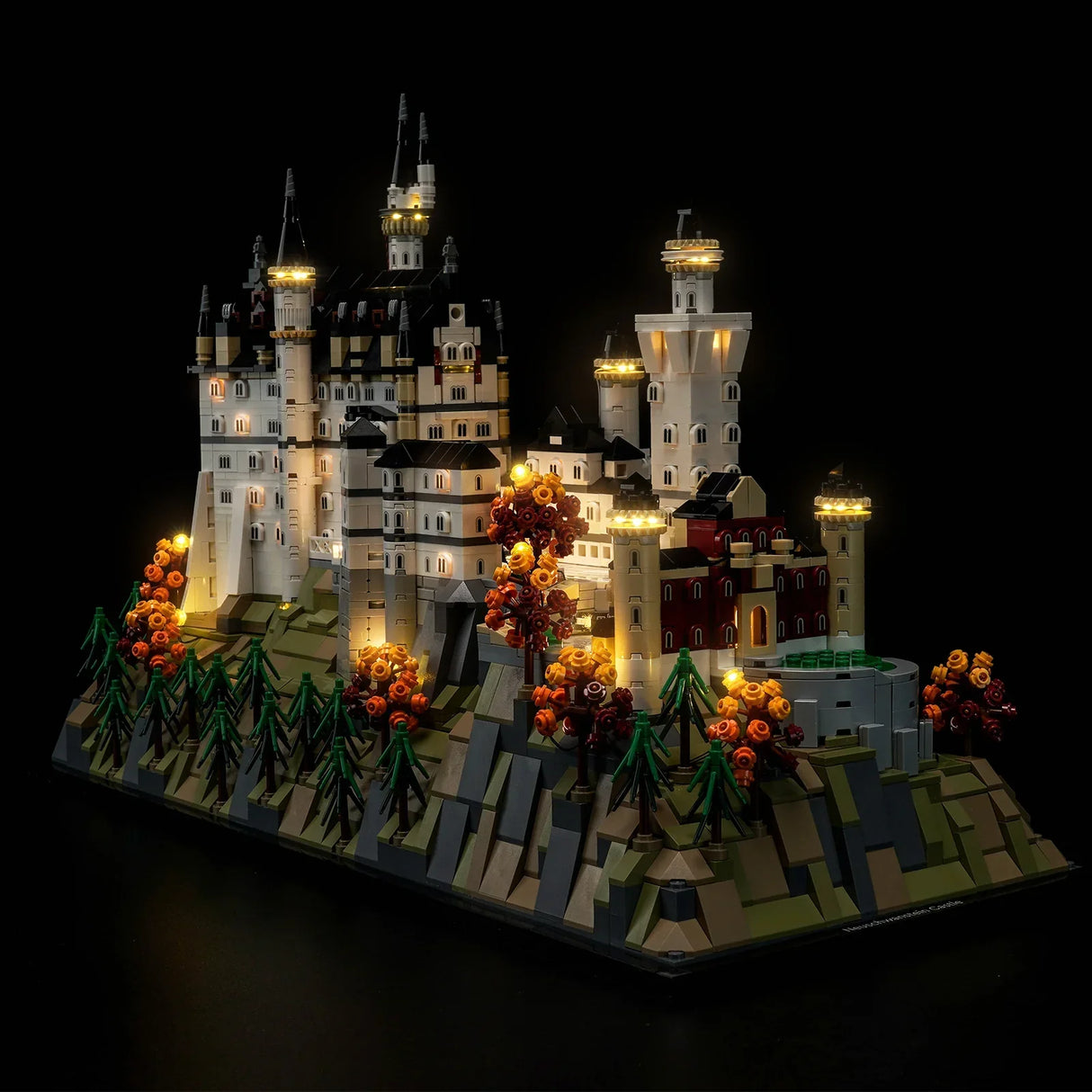 Beleuchtetes Lego Schloss Neuschwanstein auf einem Berg mit Bäumen