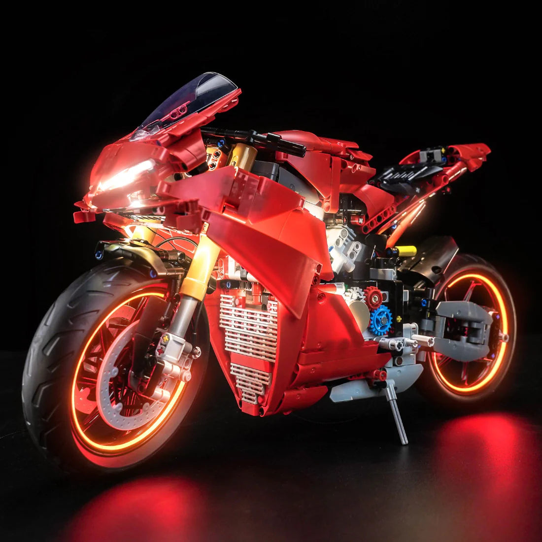 Rotes Spielzeugmotorrad mit leuchtenden Rädern und Scheinwerfern
