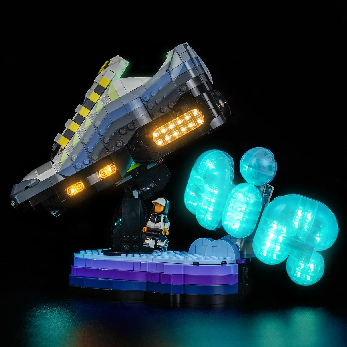 Beleuchteter Lego-Sneaker mit gelben und blauen Details, daneben eine Lego-Figur und leuchtende blaue Kugeln