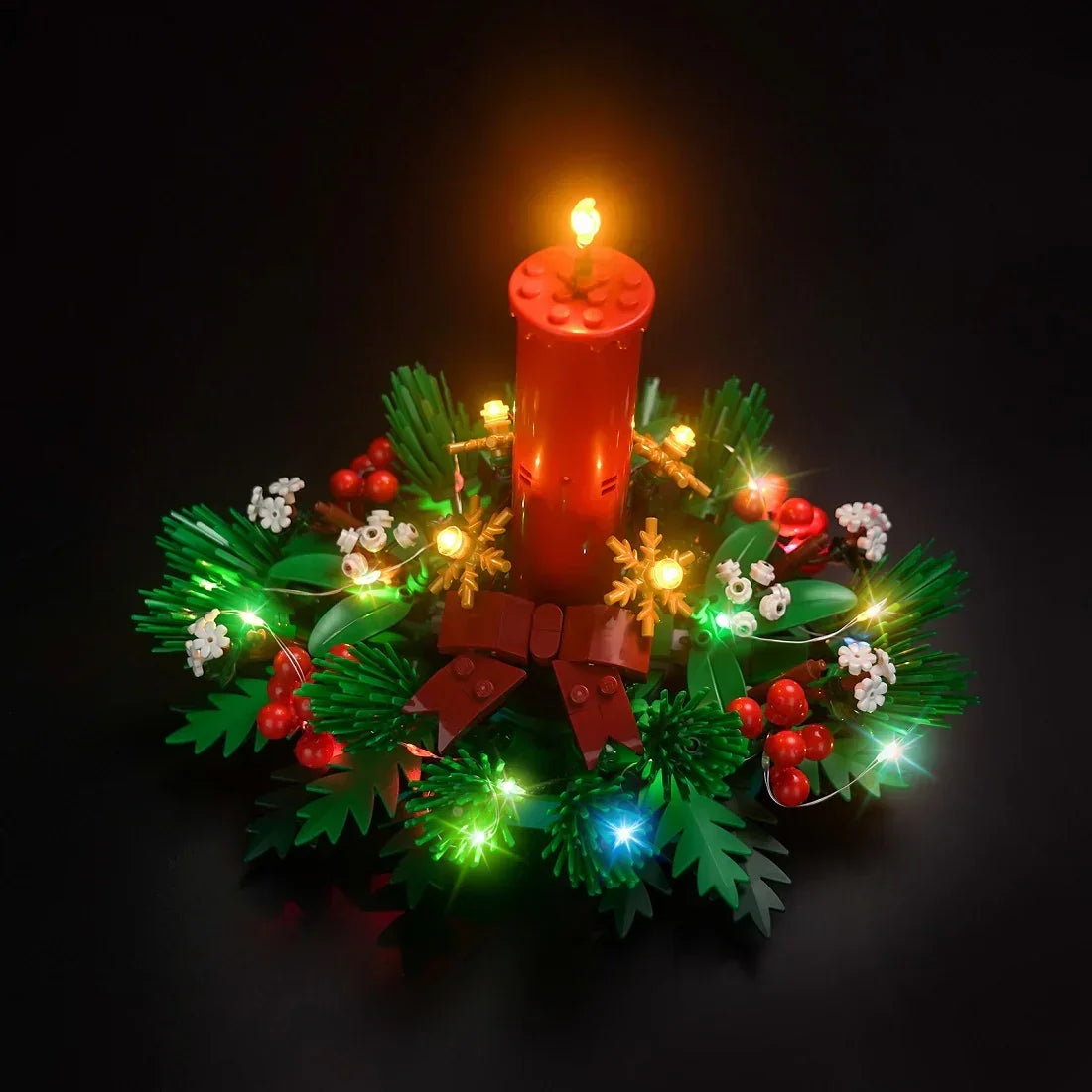 Beleuchteter Lego Adventskranz mit roter Kerze und Tannenzweigen auf schwarzem Hintergrund