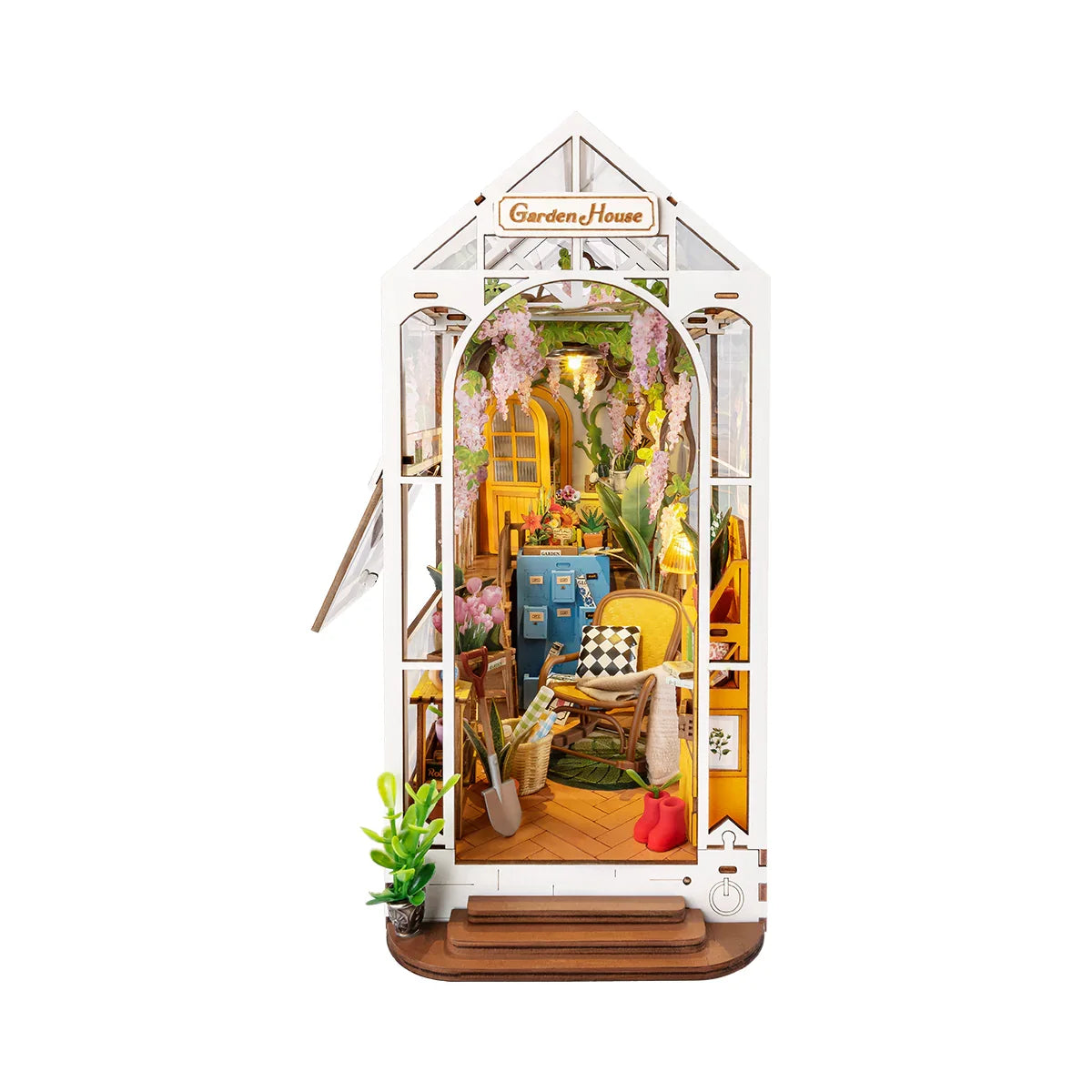 Miniaturmodell eines Gewächshauses mit Pflanzen und Gartenmöbeln