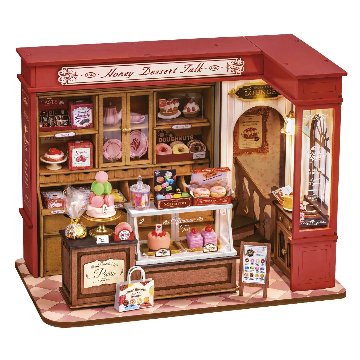 Miniatur-Konditorei mit rotem Dach, gefüllt mit Kuchen, Donuts und Macarons