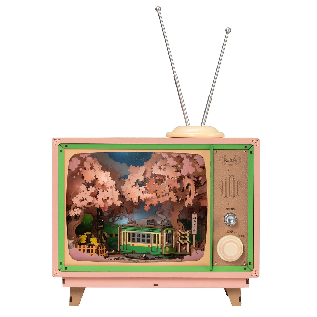 Rosa Retro-Fernseher mit einer Szene aus Kirschblüten und einer grünen Straßenbahn
