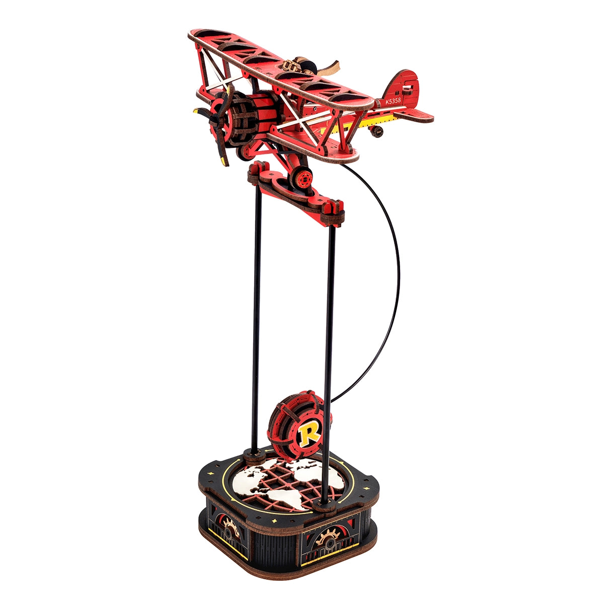 Rotes Holzflugzeugmodell auf einem Ständer mit Globusbasis