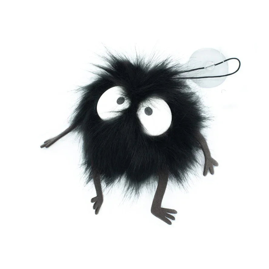 Schwarzes flauschiges Rußmännchen mit großen weißen Augen und Saugnapf