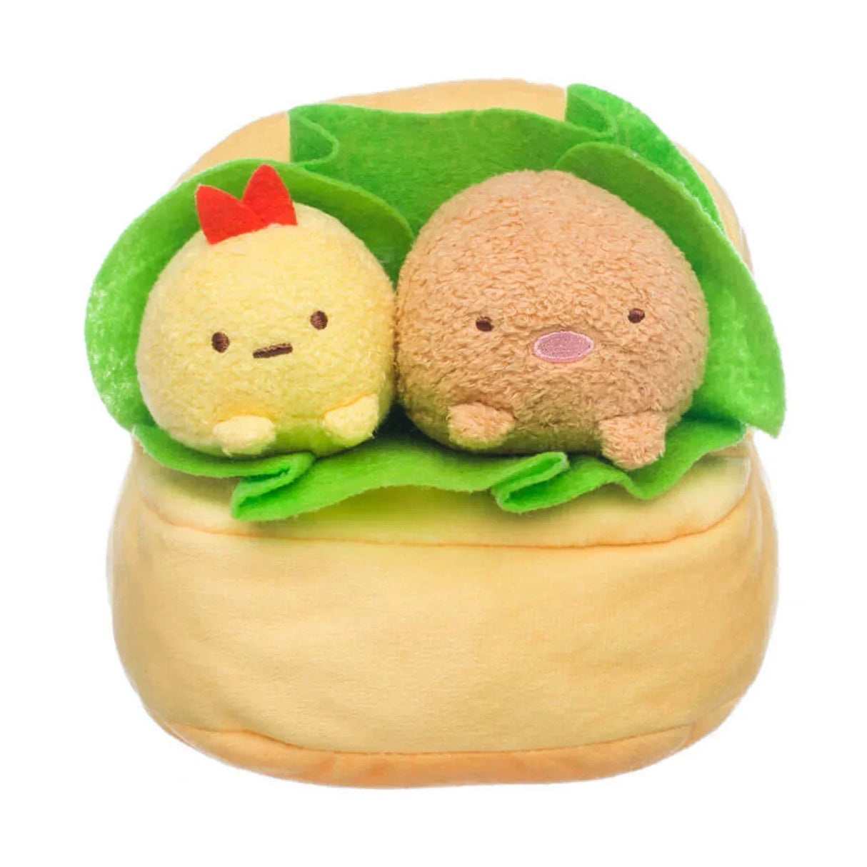 Zwei Plüschfiguren in einem Brötchen mit Salatblatt