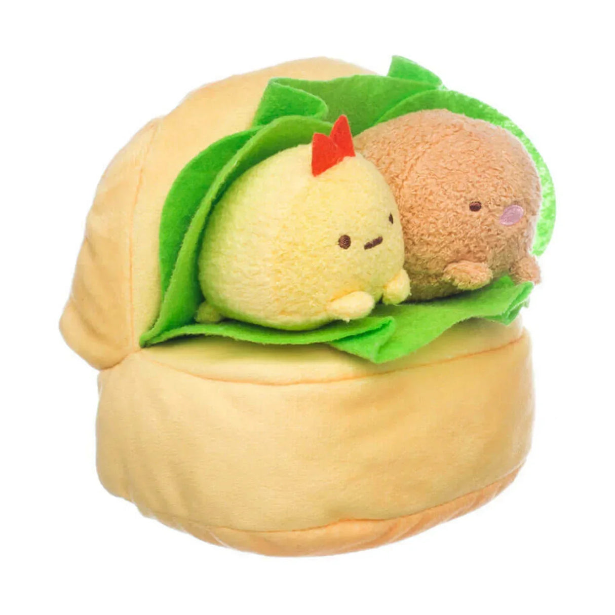 Zwei kleine Plüschfiguren in einem Brötchen mit grünem Filzblatt