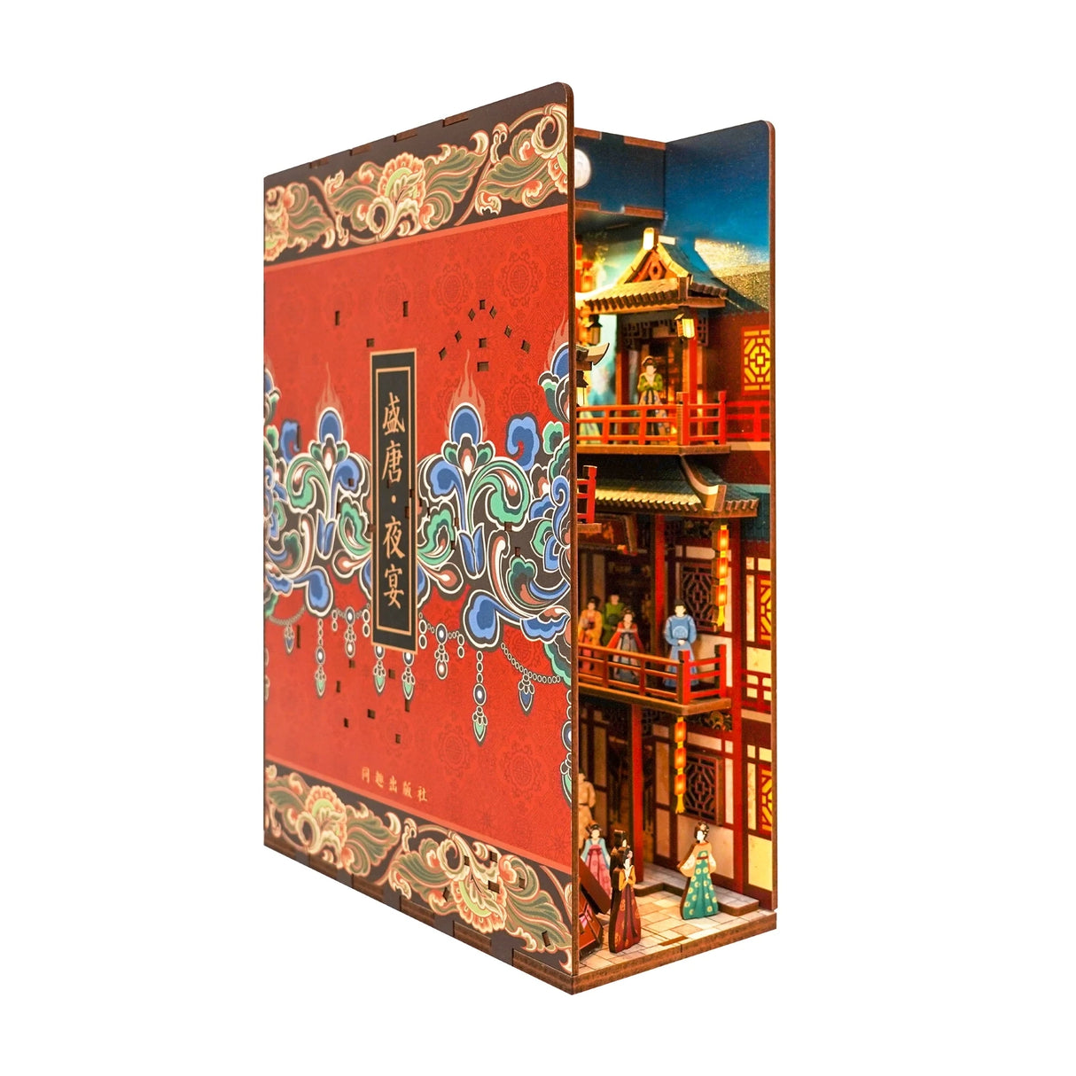 Ein Bücherregal-Einsatz mit einem roten Buchrücken und einer Miniatur-Szene eines chinesischen Gebäudes mit Figuren