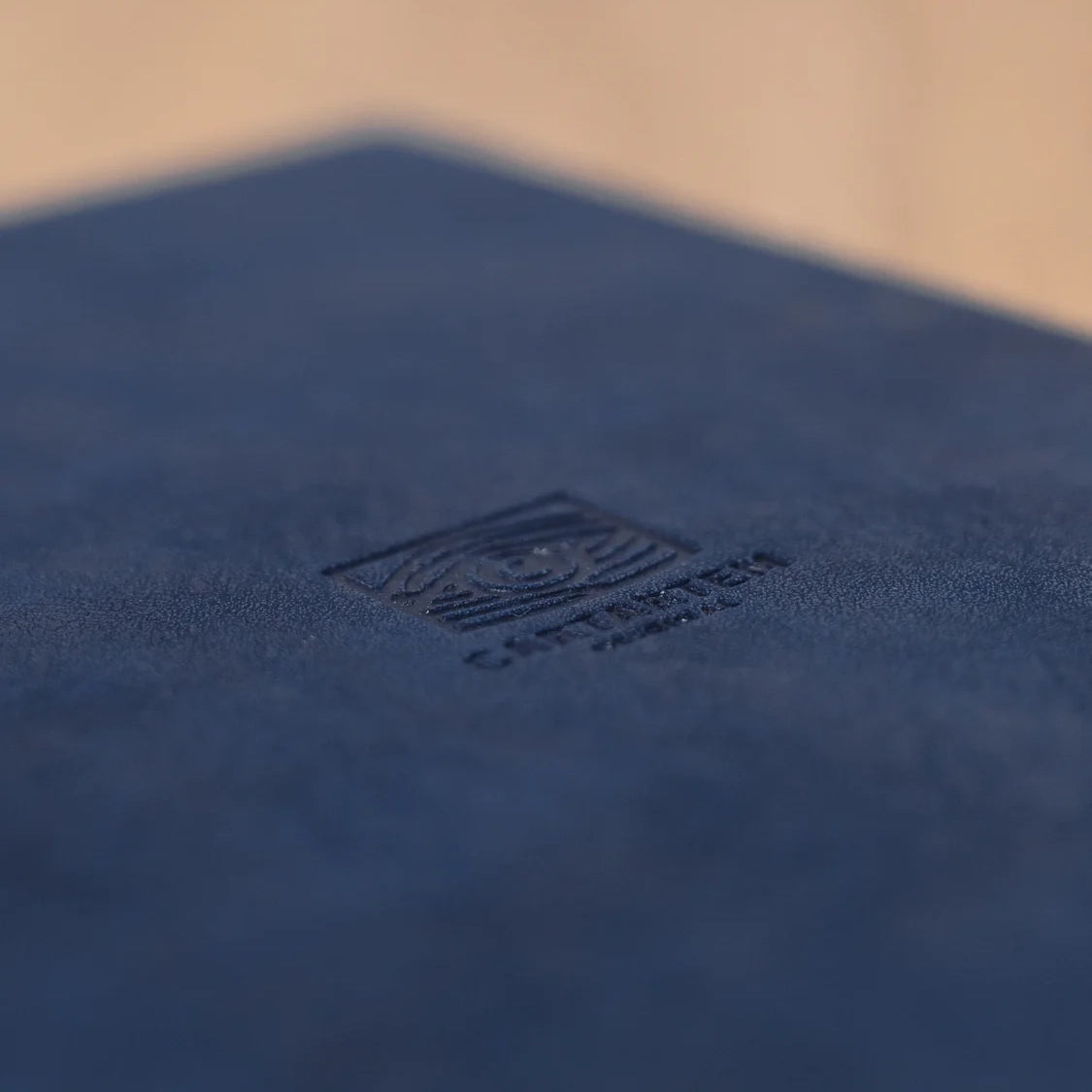 Nahaufnahme des Captain Ten Logos auf dunkelblauem Material