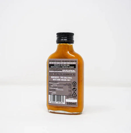 Rückseite der 7 Pot Puro Chilisauce mit Zutatenliste 7Pot Chili 75%, Weissweinessig, Salz sowie Nährwertangaben und Vegan-Symbol